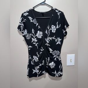 This is a White House Black market short sleeved embellished shirt. Size large.